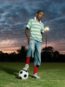 Teenage african boy with football